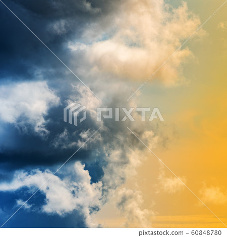 Dramatic blue thunderclouds and stunning yellow-golden fluffy clouds Dramatic blue thunderclouds and stunning yellow-golden fluffy clouds 60848780