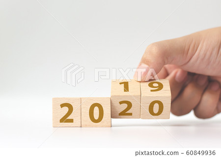 New year 2019 change to 2020 concept. Hand flip over wood cube block New year 2019 change to 2020 concept. Hand flip over wood cube block 60849936