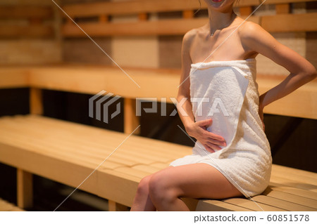 Woman entering the sauna Woman entering the sauna 60851578