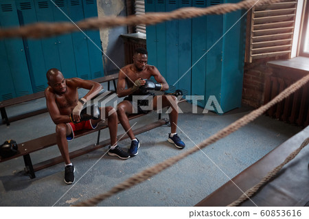Two African boxers sitting in locker room 60853616