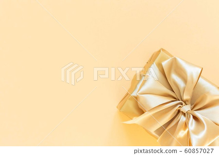 Gift box on gold background 60857027