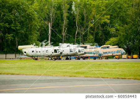 A line of retired old MI-8 helicopters 60858443