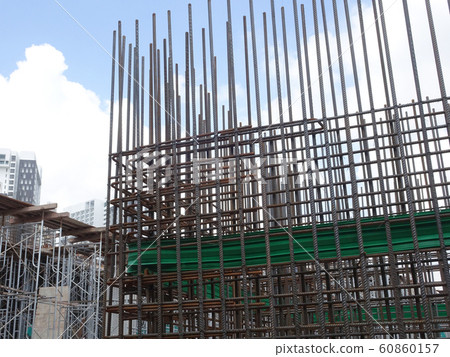 Steel reinforcement bar used to reinforced concrete at the construction site. It was tied together using tiny wires by construction workers. Steel reinforcement bar used to reinforced concrete at the construction site. It was tied together using tiny wires by construction workers. 60860157