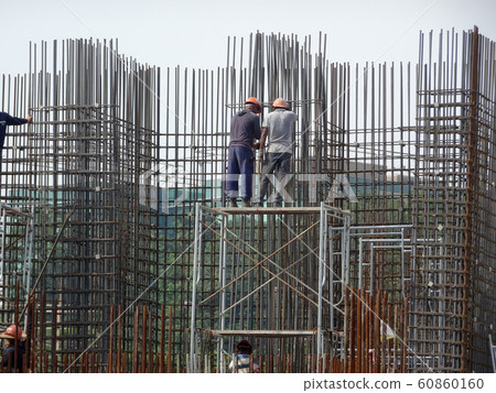 Steel reinforcement bar used to reinforced concrete at the construction site. It was tied together using tiny wires by construction workers.   60860160