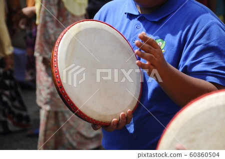 Boy plays Kompang during Malay wedding ceremony. Kompang is a Malay traditional drums that usually played during the traditional Malay wedding 60860504