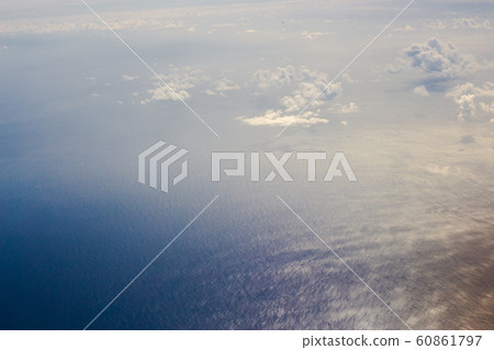 View from the porthole of an plane. Clouds over Atlantic Ocean. 60861797
