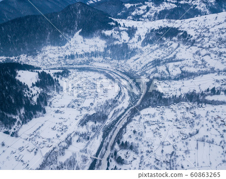 Carpathian village Kryvorivnia covered with snow 60863265