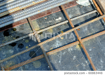 Steel reinforcement bar used to reinforced concrete at the construction site. It was tied together using tiny wires. Fabricate in-situ by construction workers. Steel reinforcement bar used to reinforced concrete at the construction site. It was tied together using tiny wires. Fabricate in-situ by construction workers. 60863448