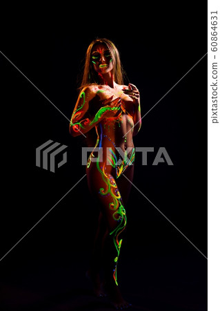 Slim girl with UV light bodyart in the dark Slim girl with UV light bodyart in the dark 60864631