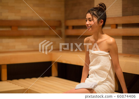 Woman entering the sauna Woman entering the sauna 60874406
