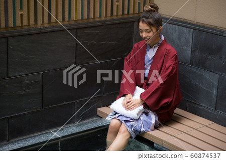 A woman entering a foot bath A woman entering a foot bath 60874537