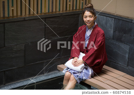 A woman entering a foot bath 60874538