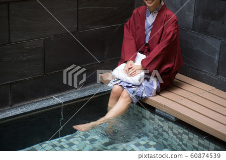 A woman entering a foot bath A woman entering a foot bath 60874539
