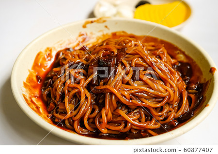 Korean Black bean noodle - jajangmyeon noodle with black sauce and vegetable in white bowl Korean Black bean noodle - jajangmyeon noodle with black sauce and vegetable in white bowl 60877407