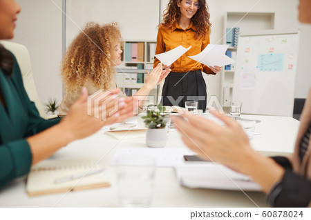 Colleagues Giving It Up For Businesswoman 60878024