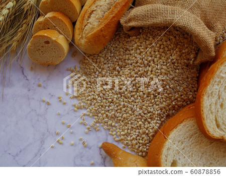 Sliced of bread and barley on a marble background Sliced of bread and barley on a marble background 60878856