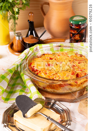 Potatoes baked with tomatoes and sweet peppers Potatoes baked with tomatoes and sweet peppers 60879216