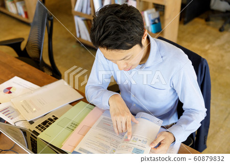 Men reading materials Men reading materials 60879832