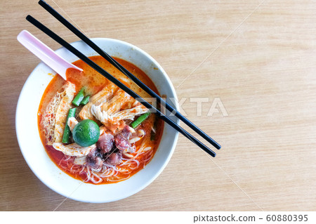 Overhead view bowl of curry laksa noodle soup with Overhead view bowl of curry laksa noodle soup with 60880395