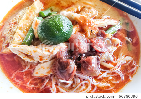 Closeup serving of delicious curry laksa noodle Closeup serving of delicious curry laksa noodle 60880396