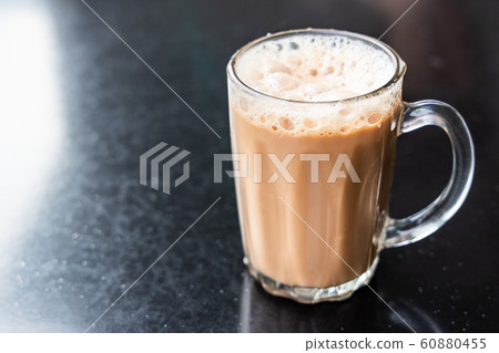 Teh tarik, milk tea with froth. Popular drink in Teh tarik, milk tea with froth. Popular drink in 60880455