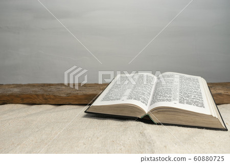 Open Holy Bible on a old wooden table and white Open Holy Bible on a old wooden table and white 60880725