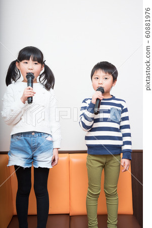 Boy and girl singing in microphone 60881976