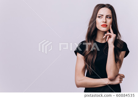 Thoughtful Young Girl in Black Dress Looking Aside Thoughtful Young Girl in Black Dress Looking Aside 60884535