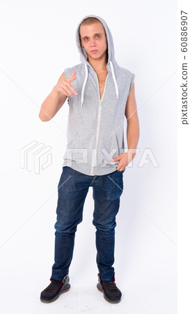 Full body shot of young bald rebellious man pointing at camera 60886907