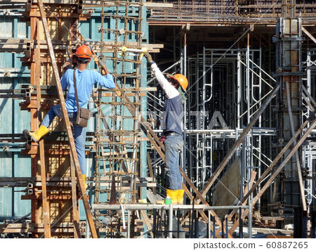 Construction workers fabricating steel reinforcement bar and timber ...