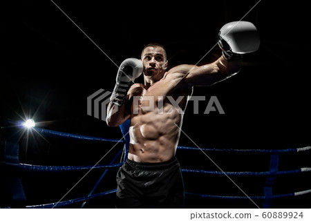 punching boxer on boxing ring 60889924