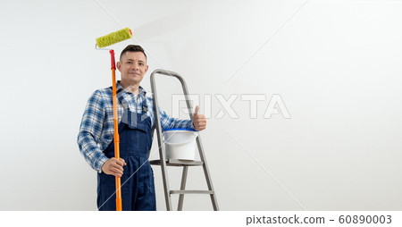 worker - painter on white wall background worker - painter on white wall background 60890003