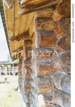 Wooden house wall, angle view of old log construction with wood texture, vertical image and close-up 60890805