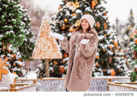 Happy girl near fir-tree branch in snow for new year. Happy girl near fir-tree branch in snow for new year. 60890976