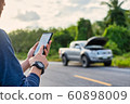 Young man make a phone call during car broken. Man need help. 60898009