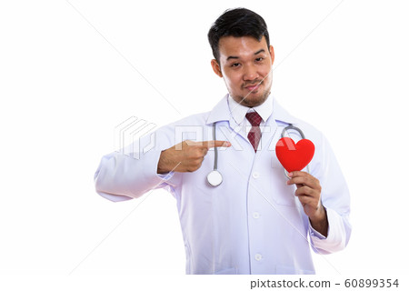 Studio shot of young Asian man doctor holding and pointing at re Studio shot of young Asian man doctor holding and pointing at re 60899354