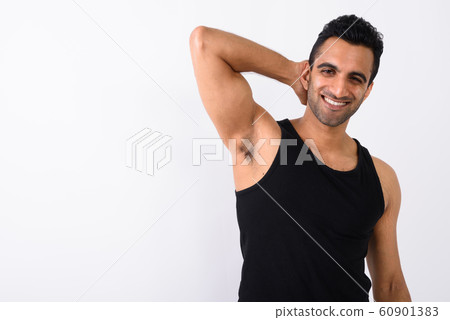 Young handsome Indian man against white background 60901383