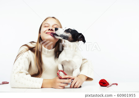pretty young blond girl with her little cute dog wearing Santas red hat at Christmas holiday isolated on white background, lifestyle people concept pretty young blond girl with her little cute dog wearing Santas red hat at Christmas holiday isolated on white background, lifestyle people concept 60901955