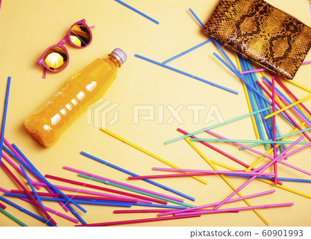 summer stuff on yellow background close up top view 60901993