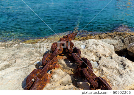 A metal chain attached to the bollard at port A metal chain attached to the bollard at port 60902206