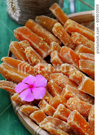 Vietnamese traditional food for Tet holiday, yellow sweet potato jam on green Vietnamese traditional food for Tet holiday, yellow sweet potato jam on green 60903009