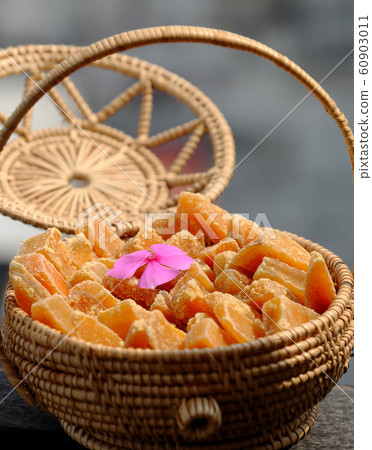 Vietnamese traditional food for Tet holiday, yellow sweet potato jam on grey Vietnamese traditional food for Tet holiday, yellow sweet potato jam on grey 60903011