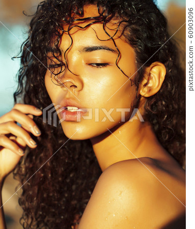 young pretty african curly girl on sunset on beach looking, lifestyle people concept 60903096