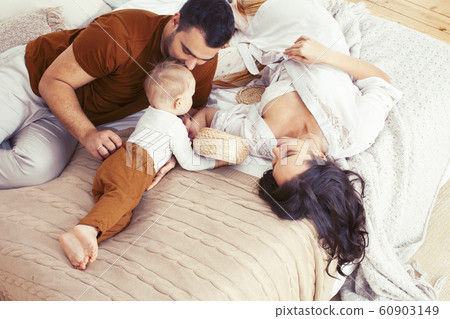 young happy family together having fun in bed, lifestyle people concept 60903149