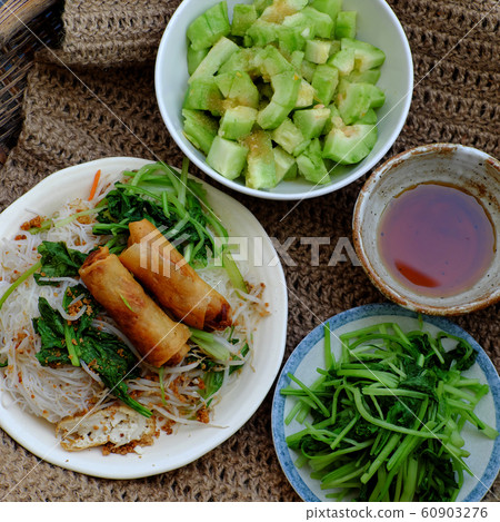 vietnamese vegetarian food for breakfast, rice noodle with fried spring roll, vegetables for vegan meal 60903276