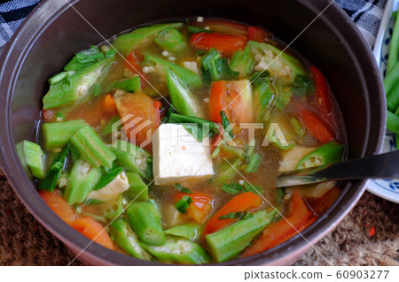 Vietnamese vegan soup in pot from vegetables are okra, tofu, tomato 60903277