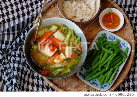 vegan food menu with boiled peas, bowl of okra, tomato, tofu soup and rice vegan food menu with boiled peas, bowl of okra, tomato, tofu soup and rice 60903280