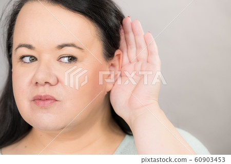Woman overhearing listening to rumors. Woman overhearing listening to rumors. 60903453