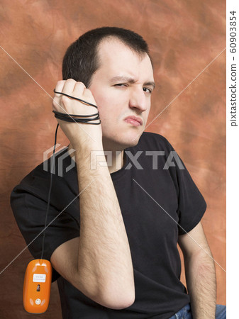 guy holds a computer mouse in his hand.portrait guy holds a computer mouse in his hand.portrait 60903854