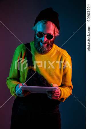 Caucasian man's portrait isolated on gradient studio background in neon light Caucasian man's portrait isolated on gradient studio background in neon light 60903994
